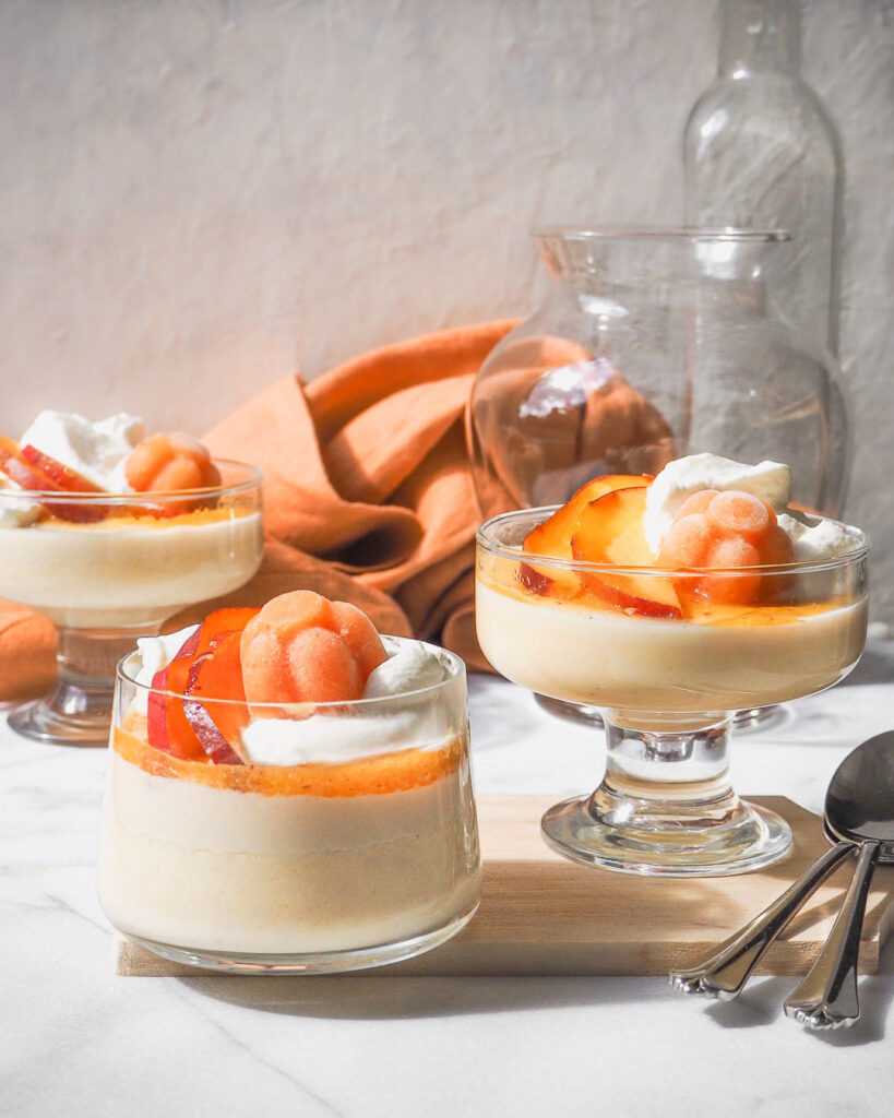 peach panna cottas in 4 glasses