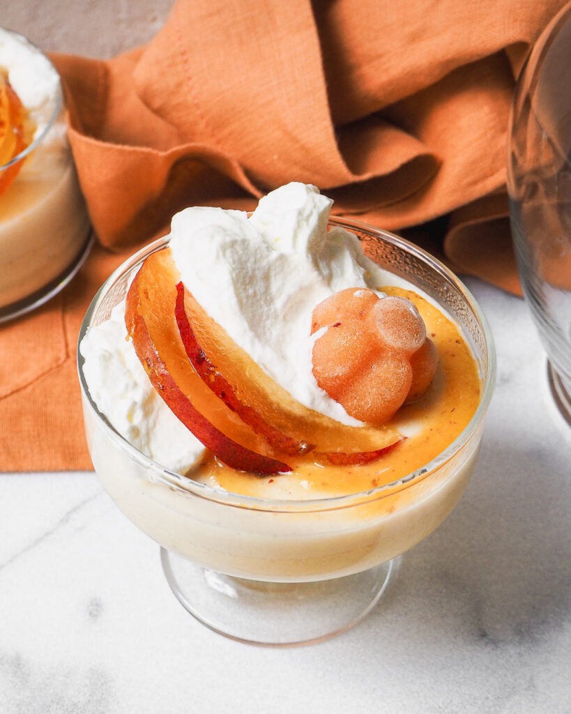 peach panna cotta with peach flower and slices