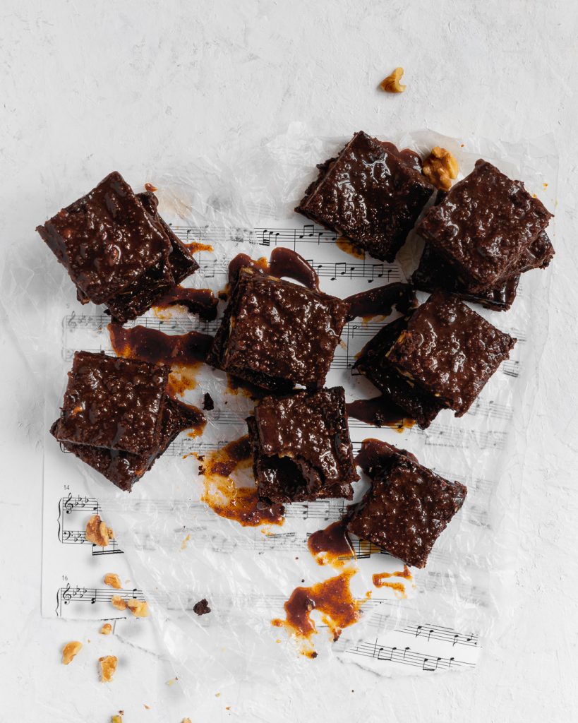 Cut squares of brownies with dripping caramel