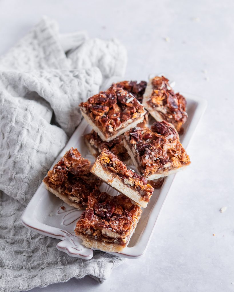 a tray filled with delicious cornflake maple pecan pie bars