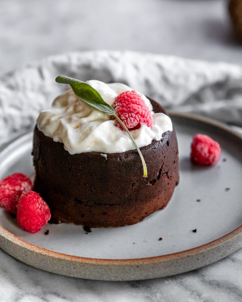 a choclate lava cake with whipped cream on a brown plate