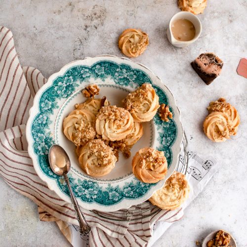 Butter swirl shaped cookies on a vintage green plate.