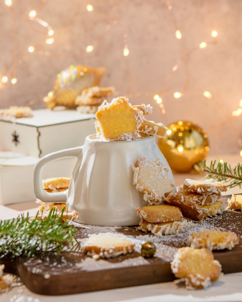 Festive Orange Coconut Star Butter Cookies on a wooden board