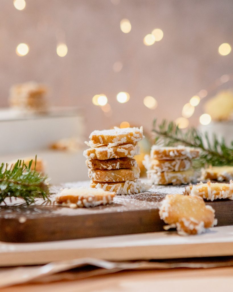 A stack of orange coconut star butter cookies