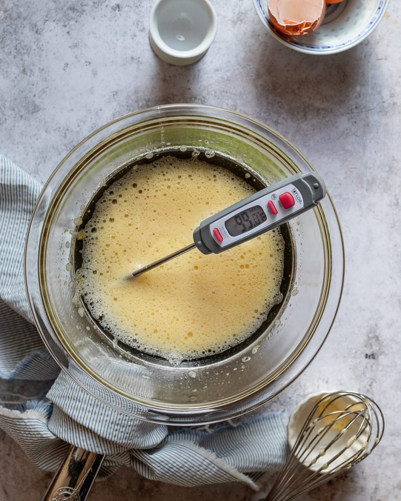 whisking eggs over a bain marie