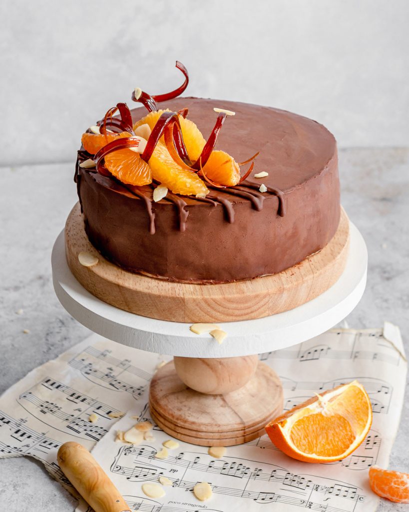 orange and sugar decorations on a chocolate cake