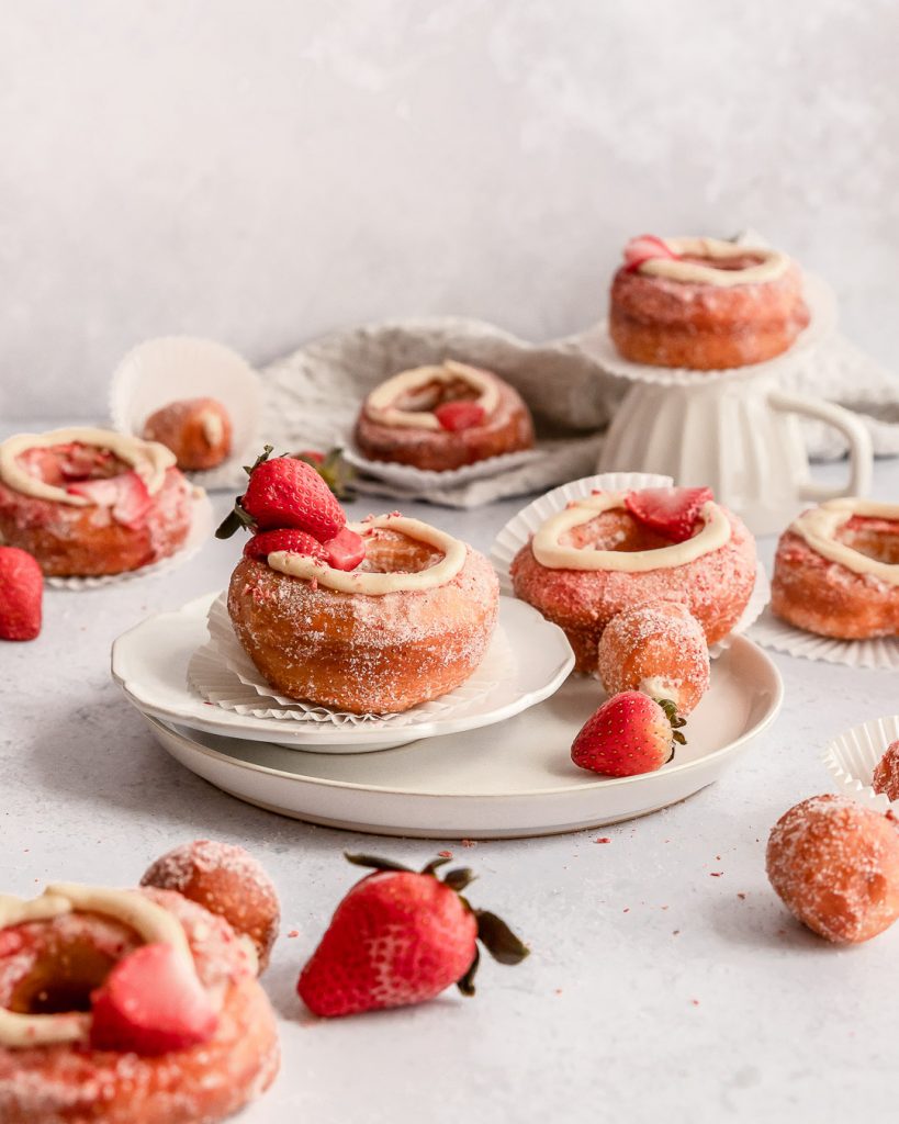 a plate stacked with cronuts with strawberries!