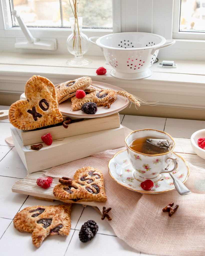 enjoying a cup of tea with berry pies