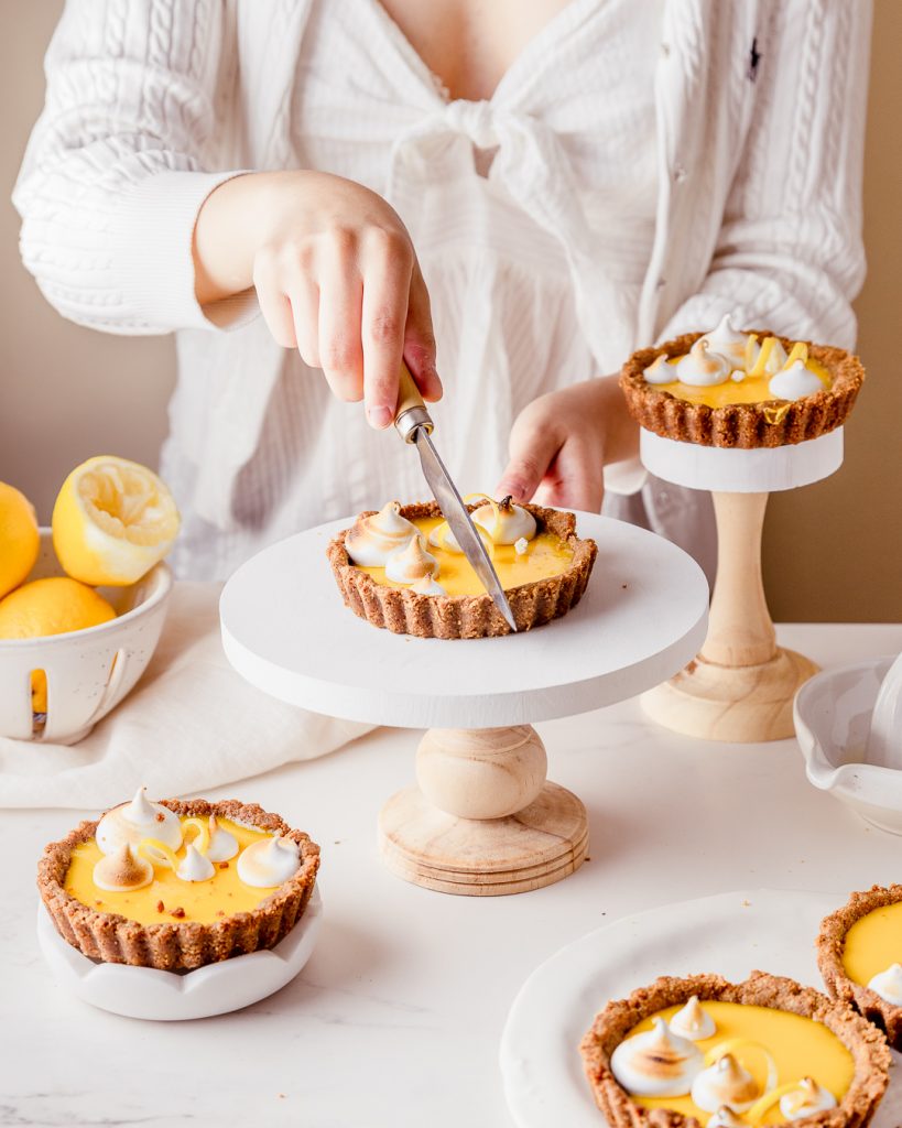 Cutting into a small lemon tart